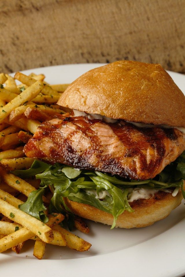 a white plate topped with a sandwich and french fries