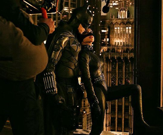 two people dressed as batman and catwoman on the set of the dark knight rises