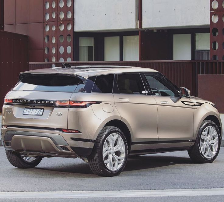 the new range rover is parked in front of a building