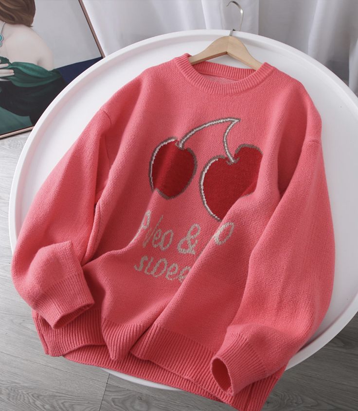 This playful pink oversized sweater is perfect for adding a fun and cozy touch to your wardrobe. The front features a charming cherry graphic, adding a whimsical vibe to the overall design. The text below the graphic reads “Sweet & Cute,” making this sweater a cheerful and stylish choice for casual days. The soft pink hue adds a pop of color to any outfit, while the relaxed fit ensures maximum comfort.Made from high-quality knit fabric, this sweater offers warmth and coziness without compromisin Cute Oversized Winter Sweater, Cute Crew Neck Sweater With Ribbed Cuffs, Trendy Crew Neck Sweater, Cute Oversized Spring Sweatshirt, Cute Long Sleeve Spring Sweater, Cozy Letter Print Sweater For Spring, Cozy Spring Sweater With Letter Print, Trendy Pink Fall Sweatshirt, Trendy Pink Sweatshirt For Fall