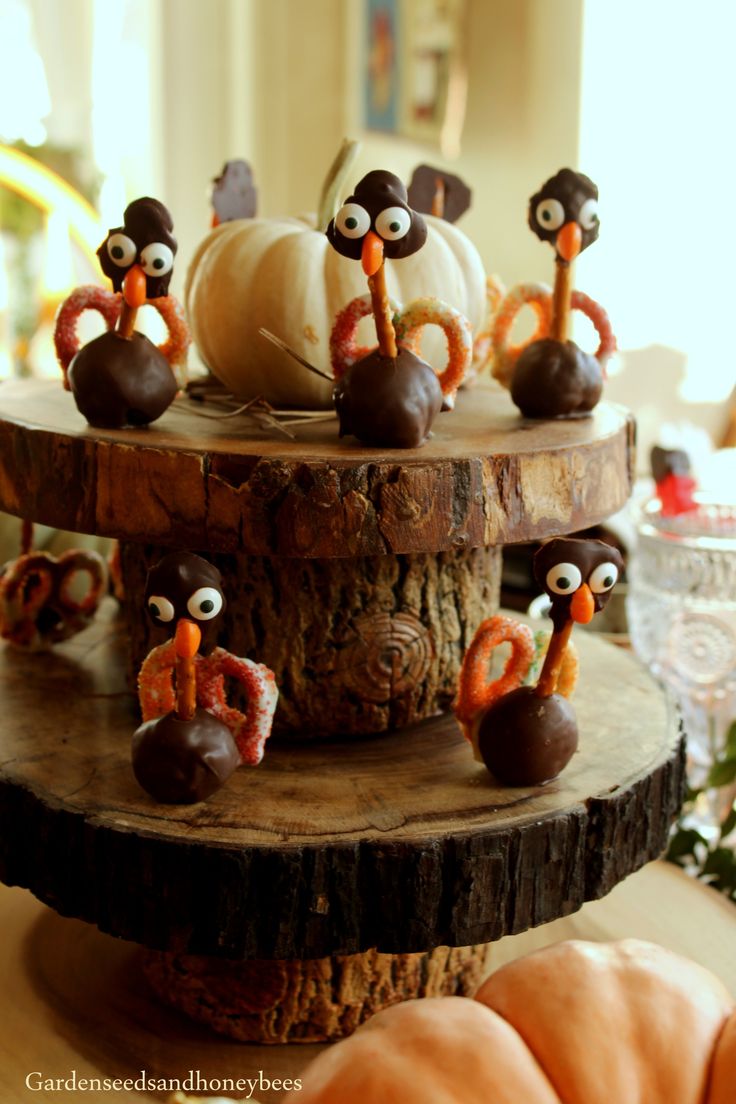 three tiered cake decorated with fake turkeys and other decorations on top of it