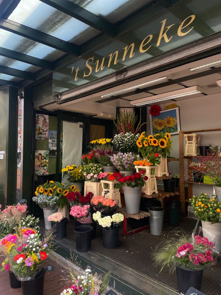 a flower shop with lots of flowers on display