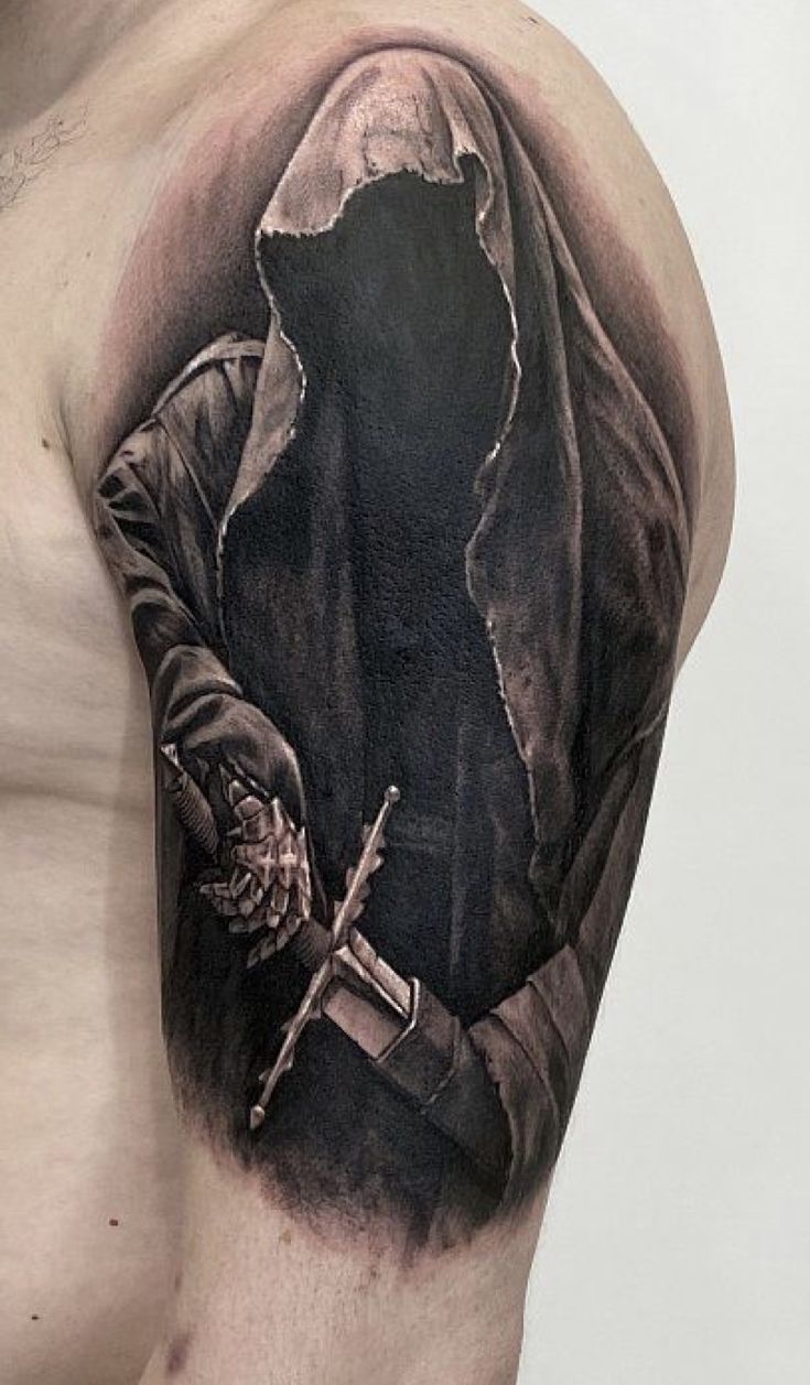 a man's half - sleeved tattoo with a hooded figure holding a knife