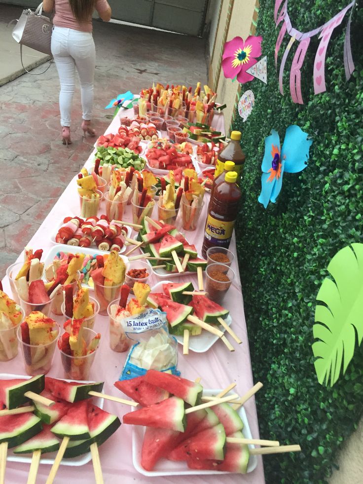 a table topped with watermelon and other foods