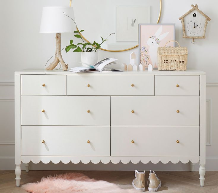 a white dresser topped with lots of drawers