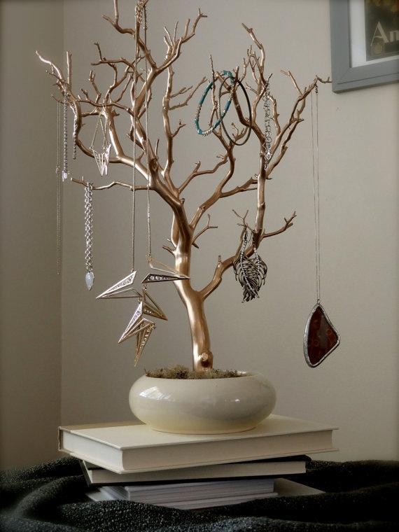 a tree with ornaments hanging from it's branches on top of a stack of books