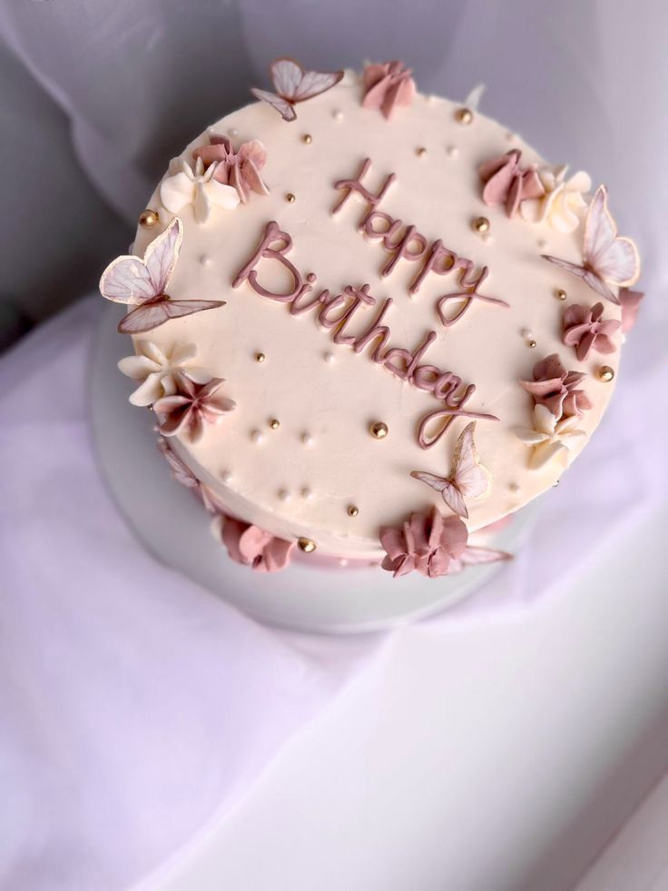 a birthday cake with pink and white decorations