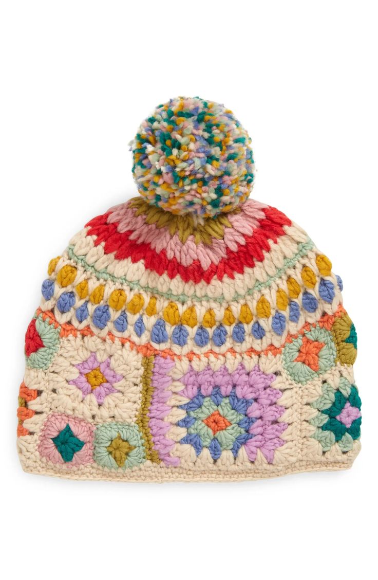 a multicolored crocheted hat with a pom - pom