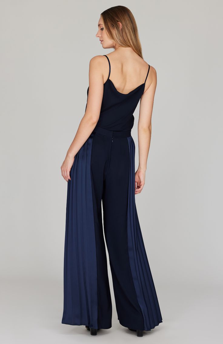 A wide leg pant featuring dramatic pleating at the sides. This pant moves beautifully as you walk and is an unexpected way to do special occasion. Finished with a back zip to maintain a clean front, this pant pairs perfectly with a matching camisole or layered with the pleat back collared shirt. Elegant Wide Leg Pants With Accordion Pleats, Elegant Evening Wide Leg Pleated Pants, Elegant Pleated Wide Leg Pants For Evening, Pleated Full Length Evening Pants, Pleated Full-length Evening Pants, Pleated Evening Pants, Elegant Straight Pants With Accordion Pleats, Elegant Pleated Pants For Party, Elegant Pleated Party Pants