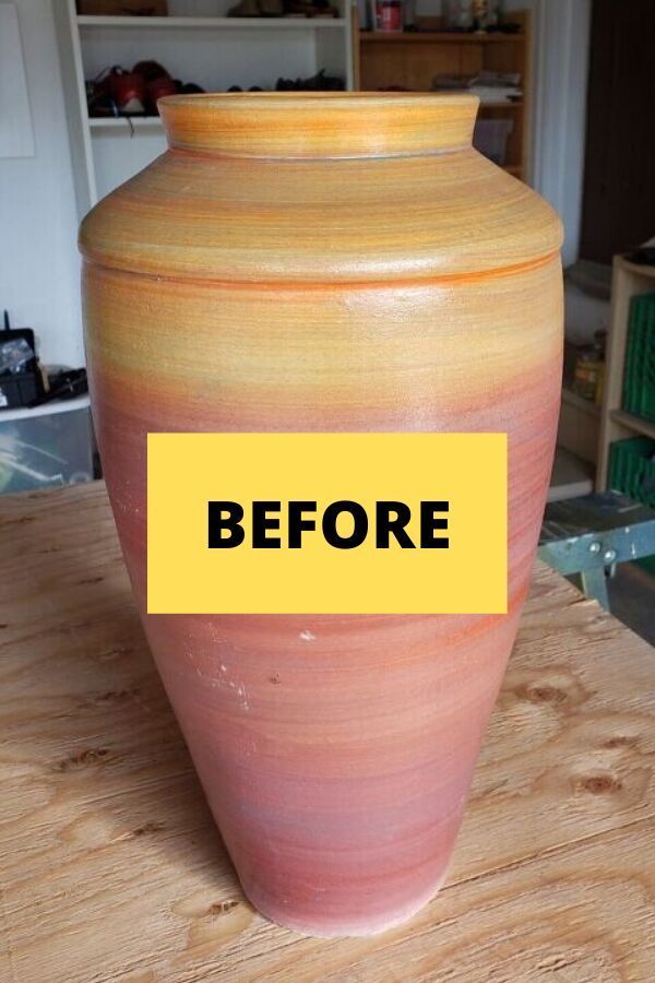 a large vase sitting on top of a wooden table next to a book shelf with a yellow sign that reads before