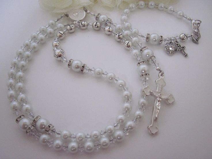 "ROSARY DETAILS: Made to Order Please note, this rosary set is stunning and loaded with Swarovski Crystals.   PERSONALIZATION: Indicate name to be personalized in the Personalization section of the listing. Maximum 10 letters, placed in the third decade of the rosary. ROSARY COLOR: White and Clear BEADS/ BEAD CAPS/ SPACERS: Pearls, Swarovski Crystals, fancy crystal rondelle spacers ROSARY CENTER: Is changed based on sacrament.  Please choose appropriate sacrament from the drop down menu. (For fi Silver Beaded Jewelry For Baptism, Silver Jewelry With 8mm Beads For First Communion, Silver Baptism Jewelry With 8mm Beads, Silver Rosary Bracelet With Round Beads For First Communion, Silver Jewelry With 8mm Beads For Baptism, Personalized Silver Rosary For Confirmation, Personalized Silver Rosary For First Communion, 8mm Bead Crucifix Jewelry For First Communion, 8mm Bead Crucifix For First Communion