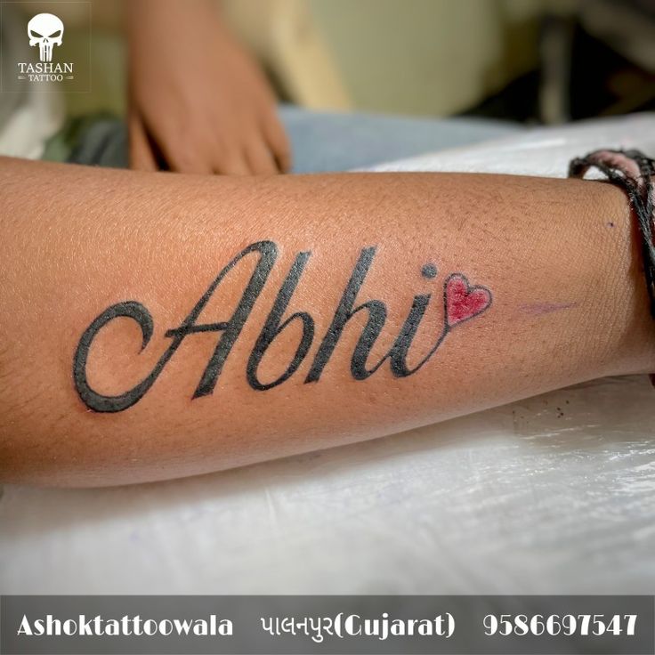 a person with a tattoo on their arm that reads abhi and has two hearts