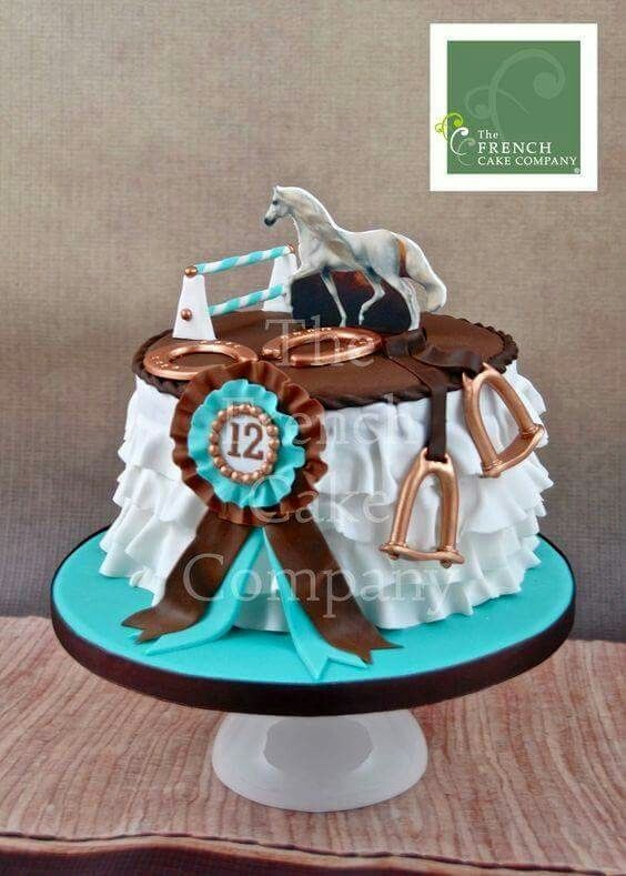 a horse themed cake with the number twelve on it's front and two horses on top