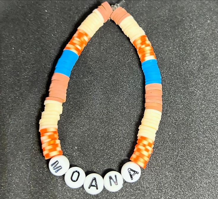 an orange and blue beaded necklace with the word aona written in white letters