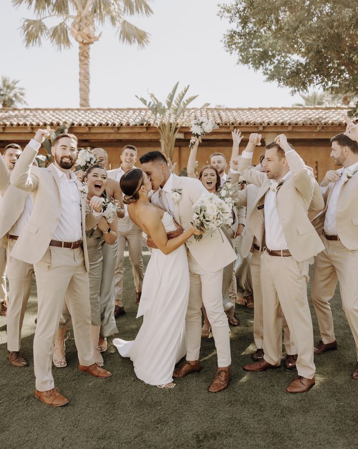 a bride and groom are surrounded by their wedding party