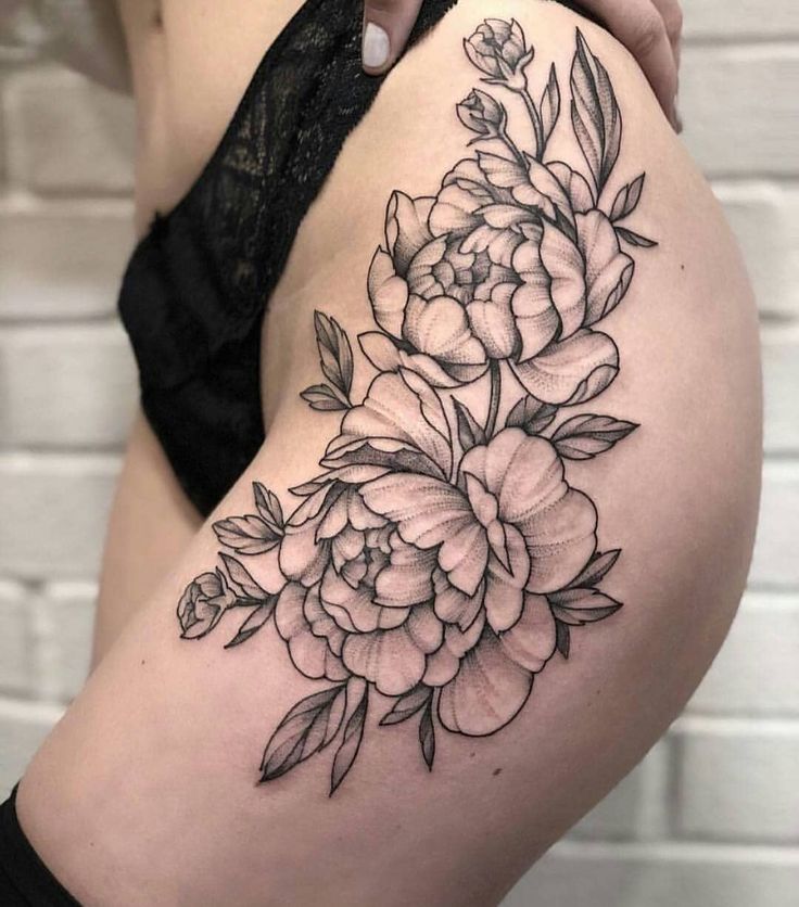 a woman's thigh with flowers on it