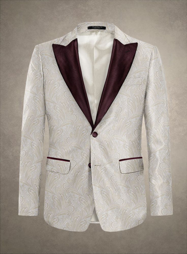 Immerse yourself in the refined elegance of our Italian Merina Tuxedo Blazer. Exquisitely crafted from pure polyester, this piece elevates beyond the ordinary, ushering in a world of luxurious sophistication. Its creamy hue, complemented by subtle golden accents, exudes timeless opulence and elegance. Perfect for everything from grand galas to intimate gatherings, this blazer promises to be your essential companion for every prestigious event.  An elusive unique piece from our Red Carpet Collection.   Look features a 2 button tuxedo jacket with wine cherry satin wide peak lapel, matching satin covered buttons, single vent and three cuff buttons.  Click 'Customize Now' to modify the look if needed.  Jacket is fully lined.  Lining: Viscose.     We have sourced stocks from the finest reputed Italian Suit, Tuxedo Blazer, Linen Suits, Tweed Suits, Peak Lapel, Tuxedo Jacket, Double Breasted Suit, Fabric Samples, In A World