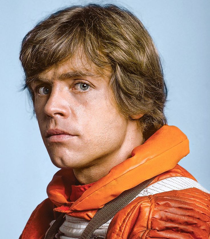 a close up of a person wearing an orange jacket