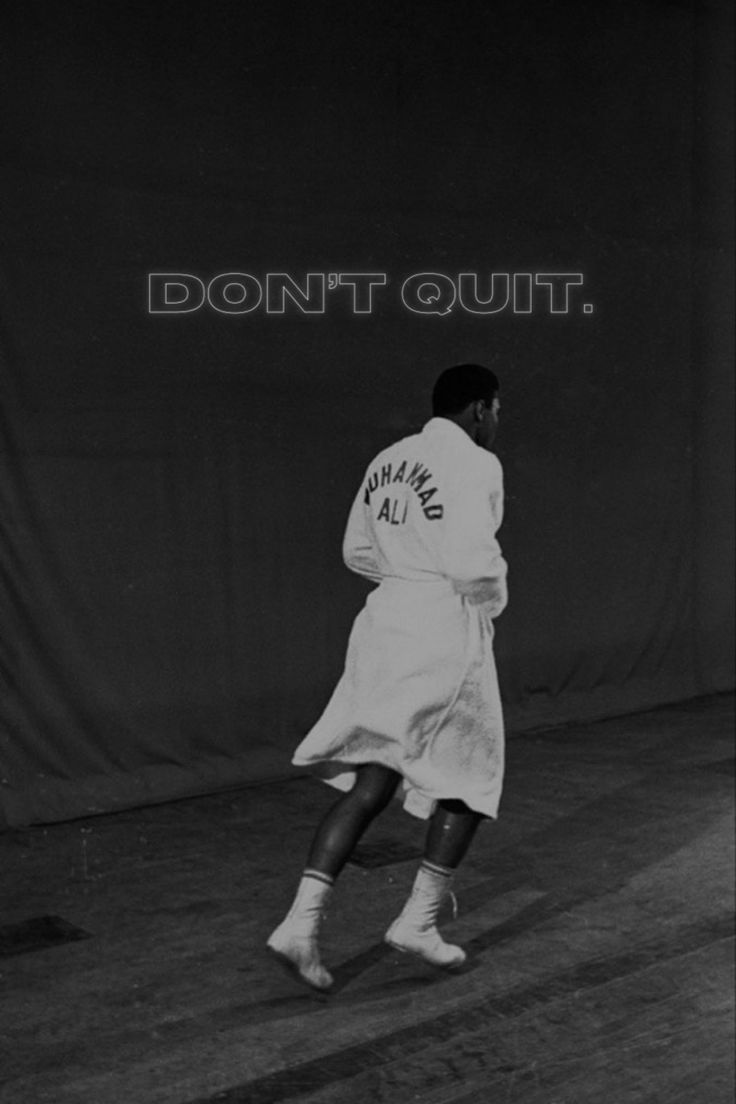 a black and white photo of a tennis player in the middle of a court that says don't quit