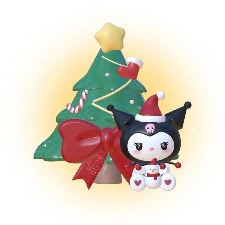 a small black and white cat sitting next to a christmas tree with decorations on it