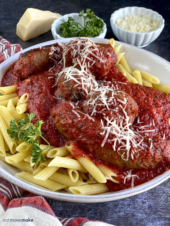 a plate of pasta with meatballs and parmesan cheese