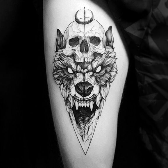 a black and white photo of a tattoo with a wolf's head