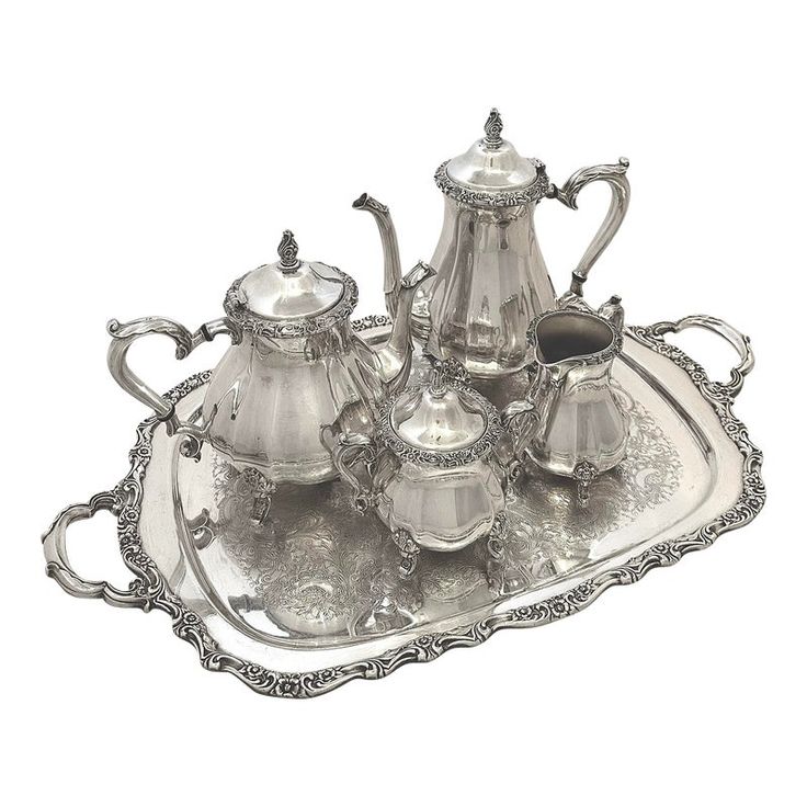 an antique silver tea set on a tray