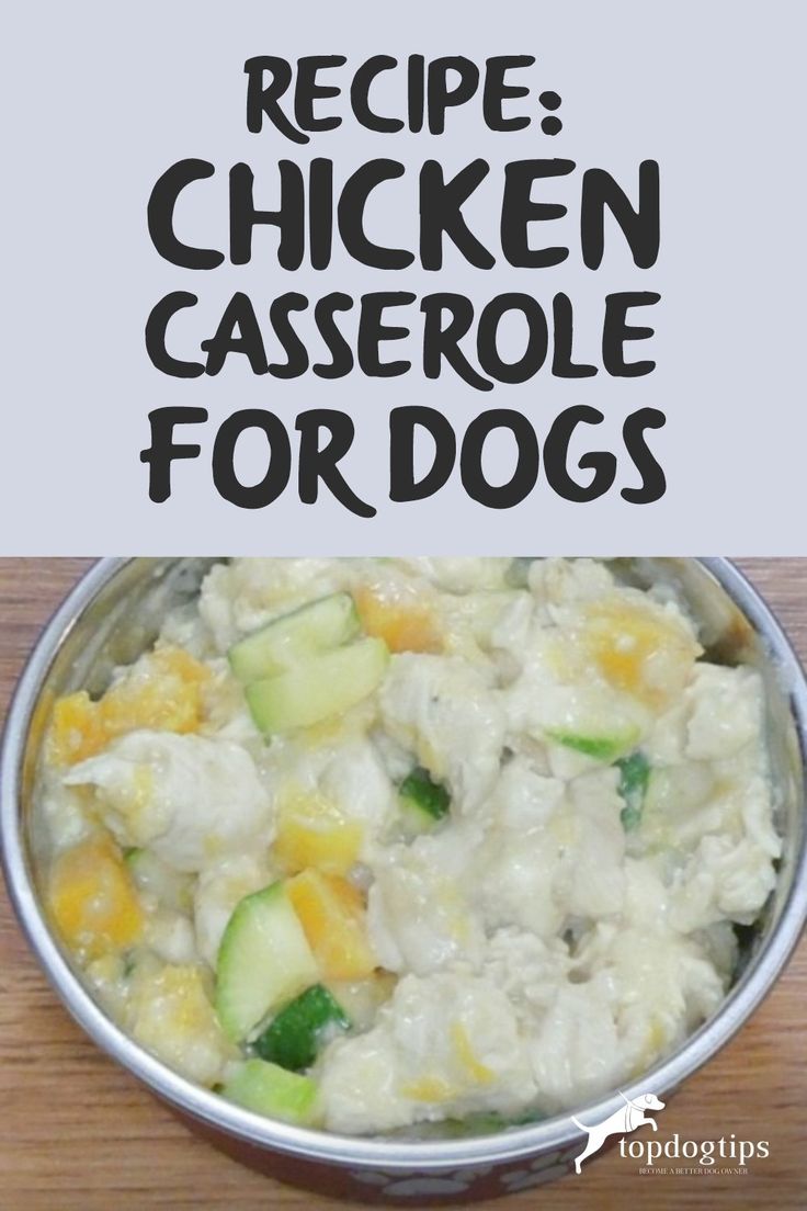 a metal bowl filled with chicken casserole and cucumbers on top of a wooden table