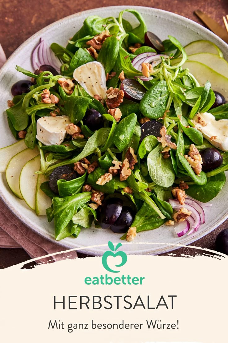 a white plate topped with salad next to a fork