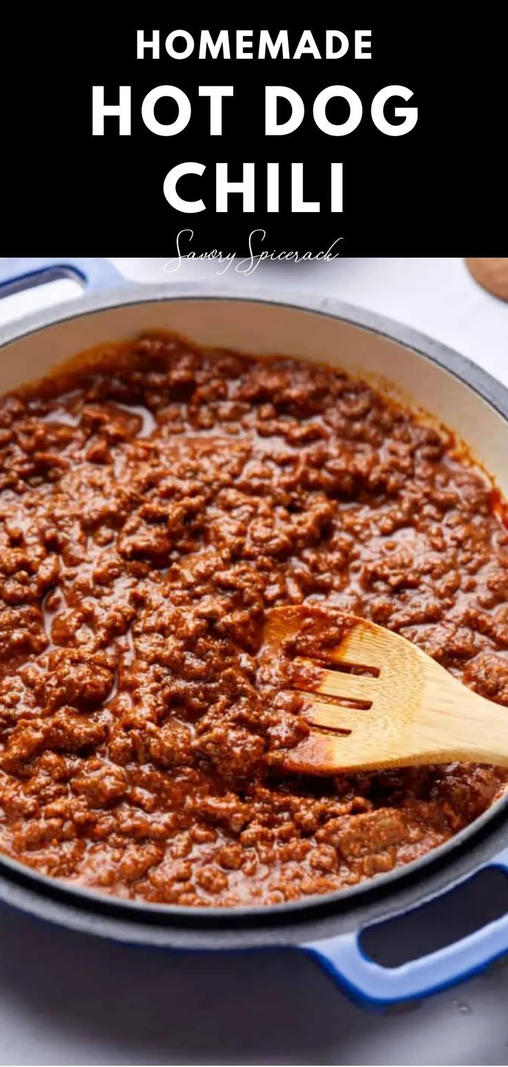 homemade hot dog chili in a pan with a wooden spoon