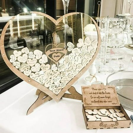 there is a heart shaped display on the table with wine glasses and other items in front of it