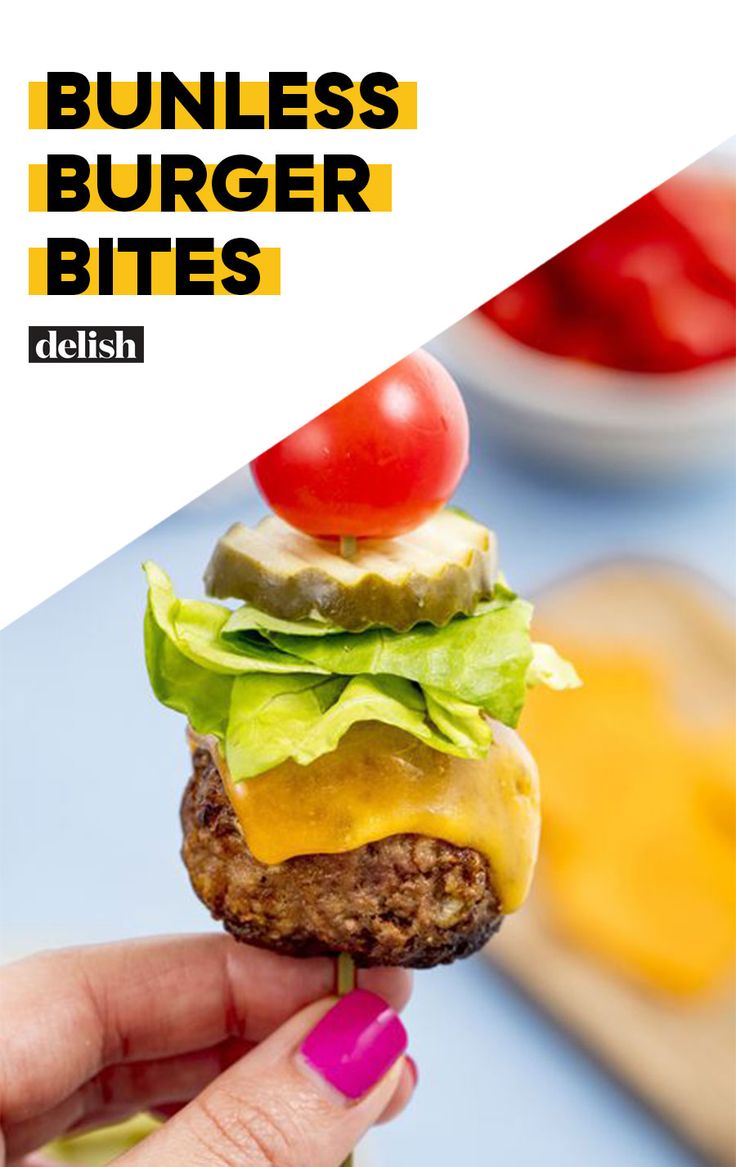 a hamburger with lettuce, tomato and cheese is being held up to the camera