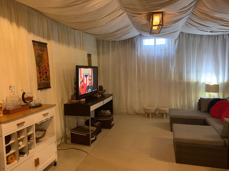 a living room filled with furniture and a flat screen tv