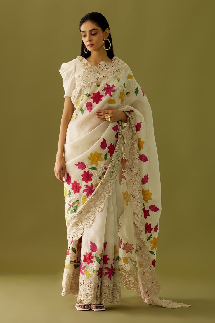 Ivory organza saree with multi colored floral embroidered appliques and cutwork hem. Comes with matching chanderi blouse  piece.
Component: 1
Pattern: Embroidered
Type Of Work: Floral Appliques
Fabric: Organza, Chanderi
Color: Ivory
Other Details: 
Cutwork detailing
Note: The blouse worn by the model is not for sale
Occasion: Destination Wedding - Aza Fashions Cutwork Saree, Alaska Fashion, Heavy Embroidery, Organza Saree, Sequins Embroidery, Silk Organza, Thread Work, Bollywood Saree, Floral Applique