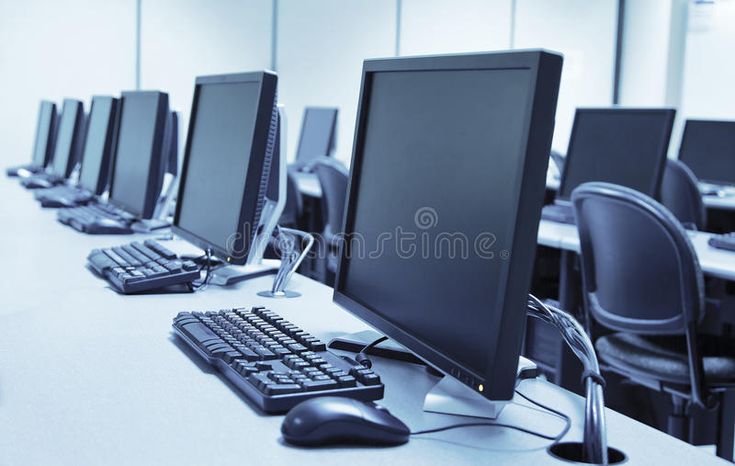 rows of computer monitors and keyboards on a desk in an office setting royalty images, stock photos