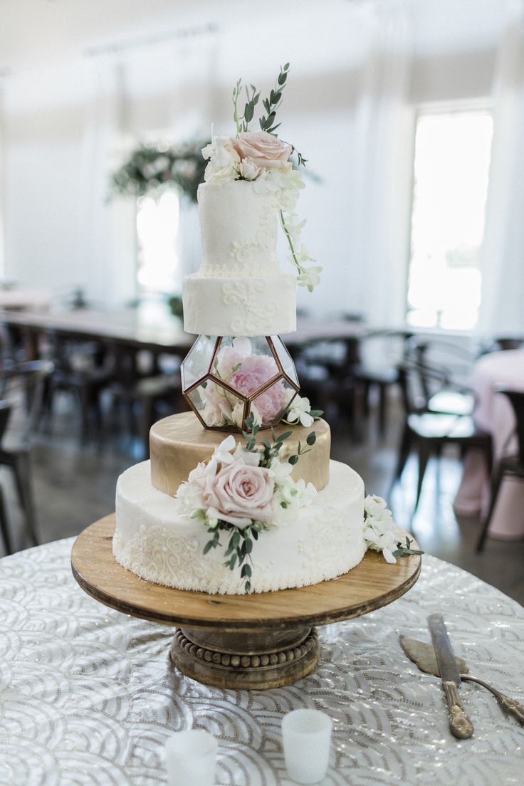 a three tiered wedding cake on top of a table