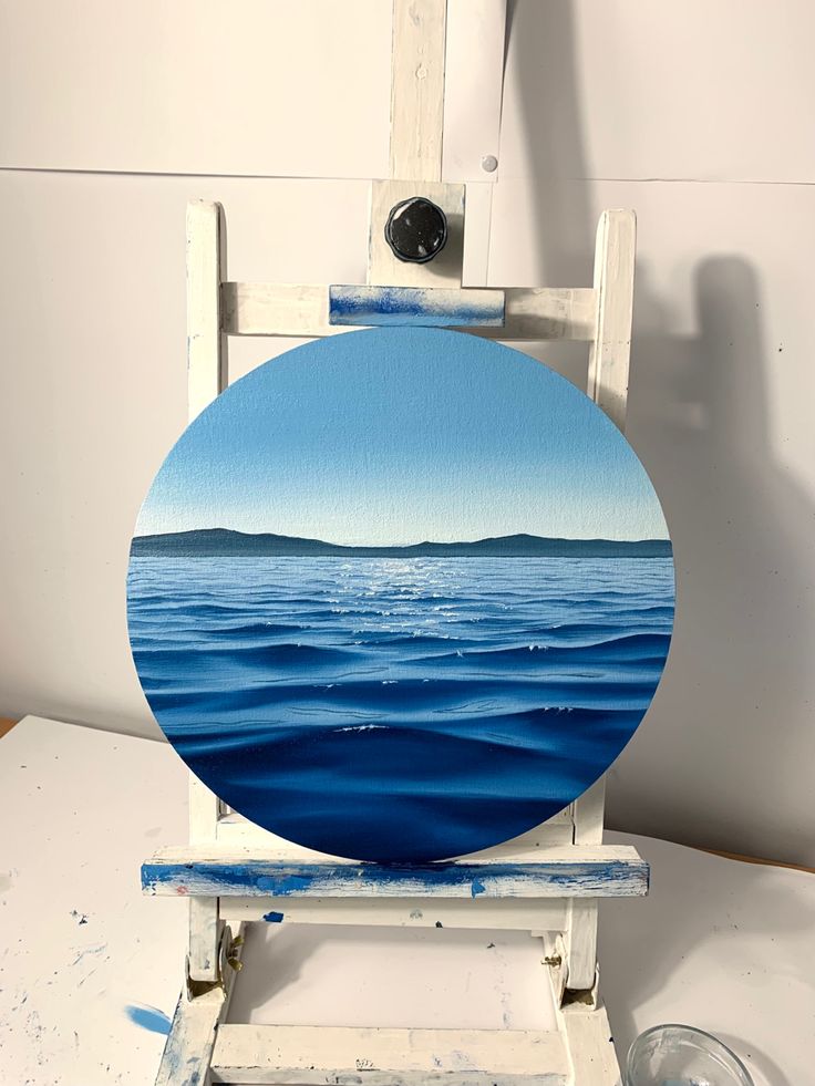 an easel with a blue painting on it