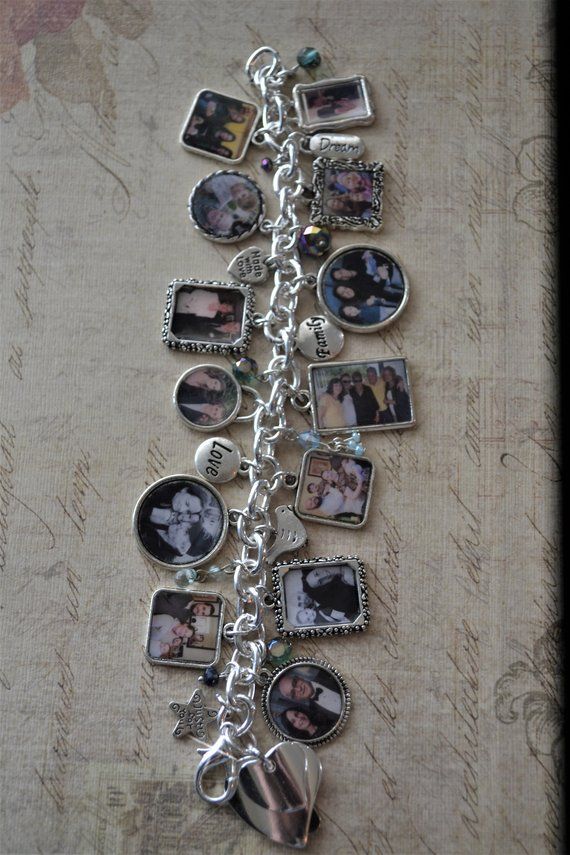 a silver bracelet with pictures and charms on it