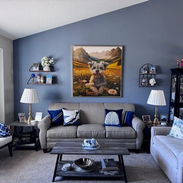 a living room with two couches, a coffee table and a painting on the wall