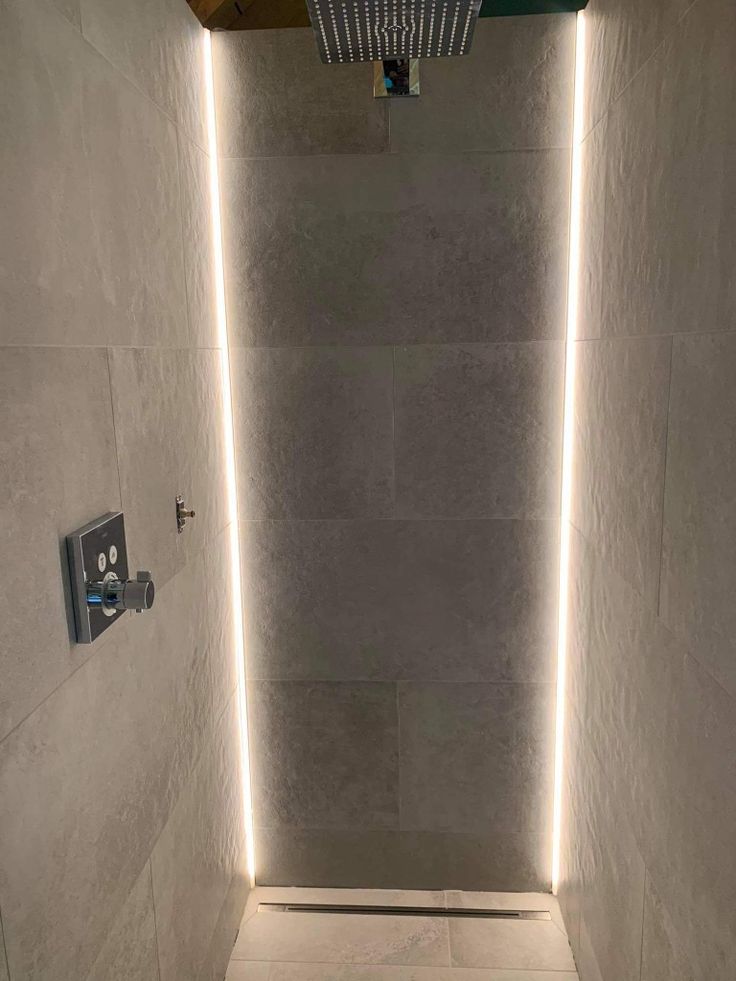 a bathroom with some lights on the wall