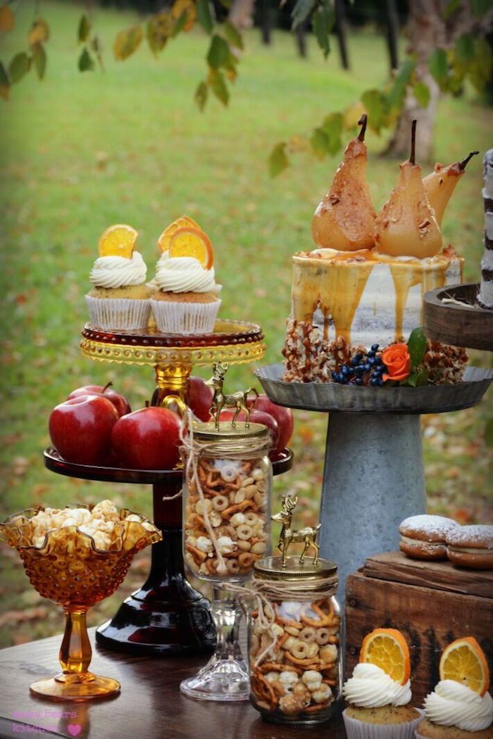 a table topped with lots of food and desserts