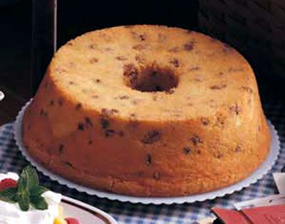 a cake sitting on top of a table next to plates with desserts around it