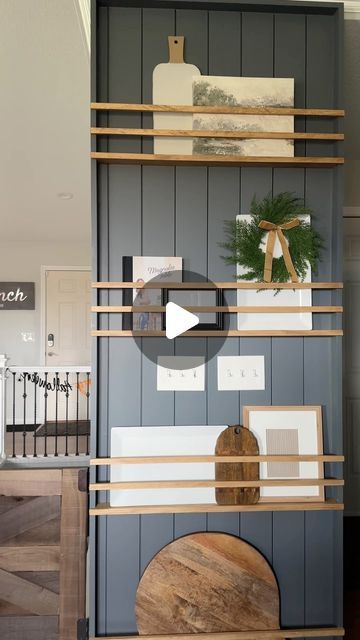 a living room filled with furniture next to a wooden shelf covered in pictures and decorations