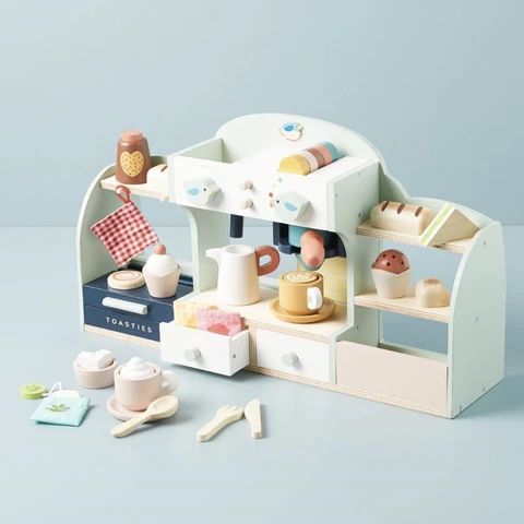 a play kitchen set with tea pots, cups and saucers on the counter top