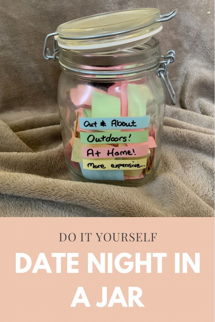 a jar filled with notes sitting on top of a bed