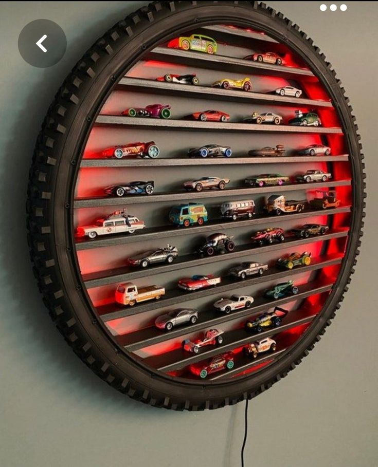 a clock made out of tire rims with cars on it