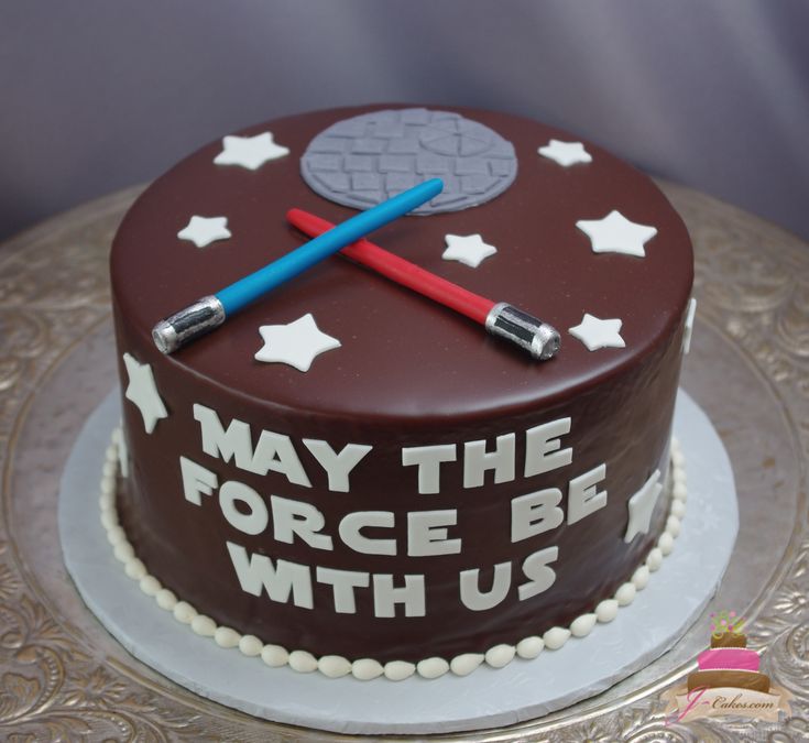 a star wars themed cake on top of a silver platter that says, may the force be with us