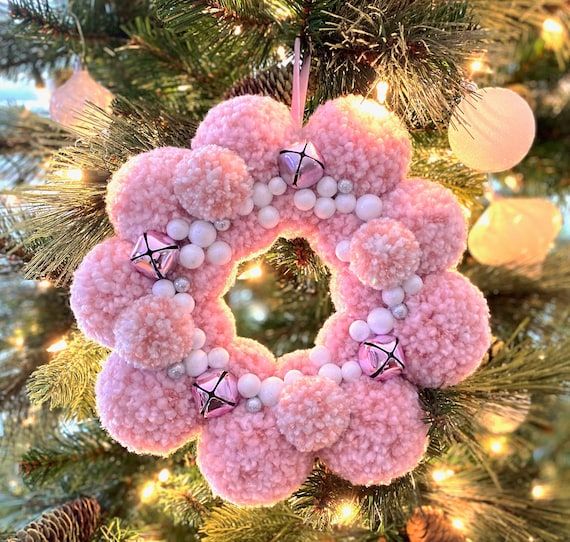 a crocheted wreath hanging from a christmas tree