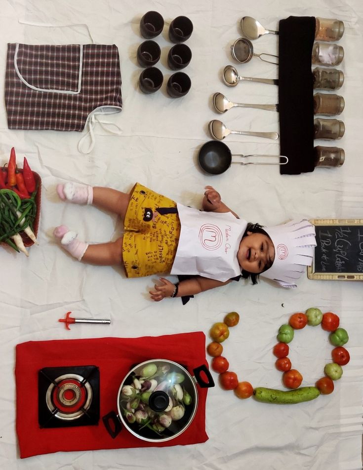 a doll laying on top of a table covered in food