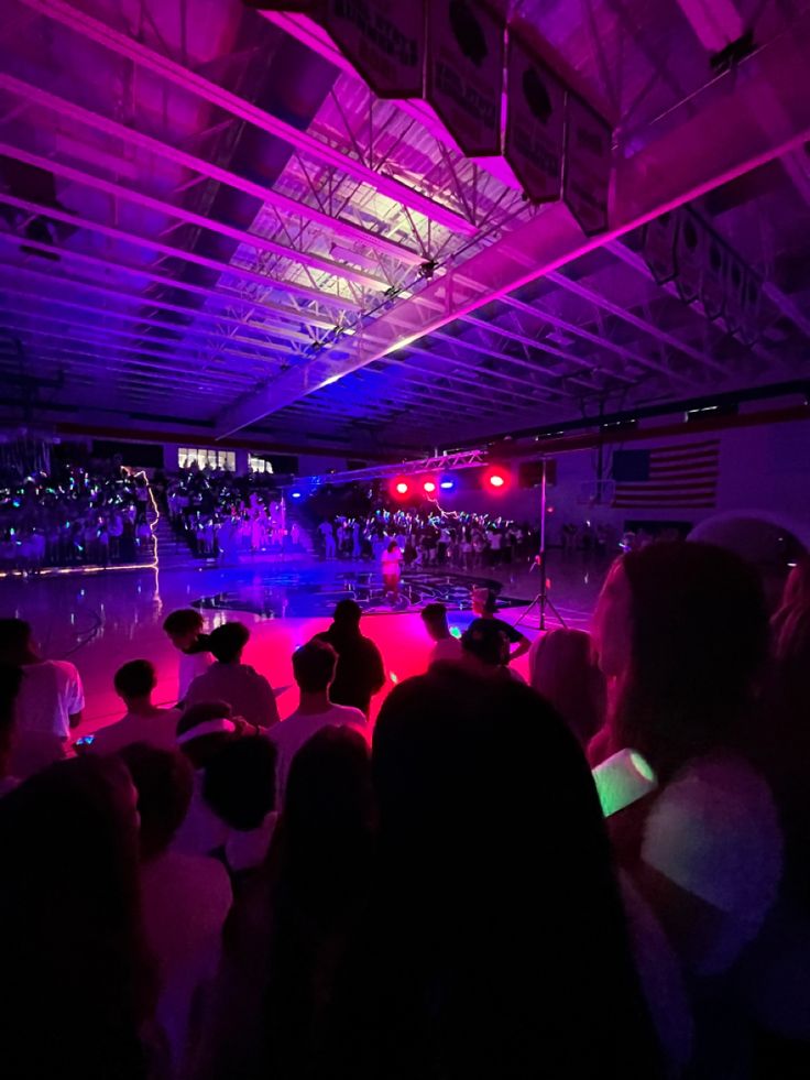 a group of people sitting on top of a stage in front of an audience at a concert